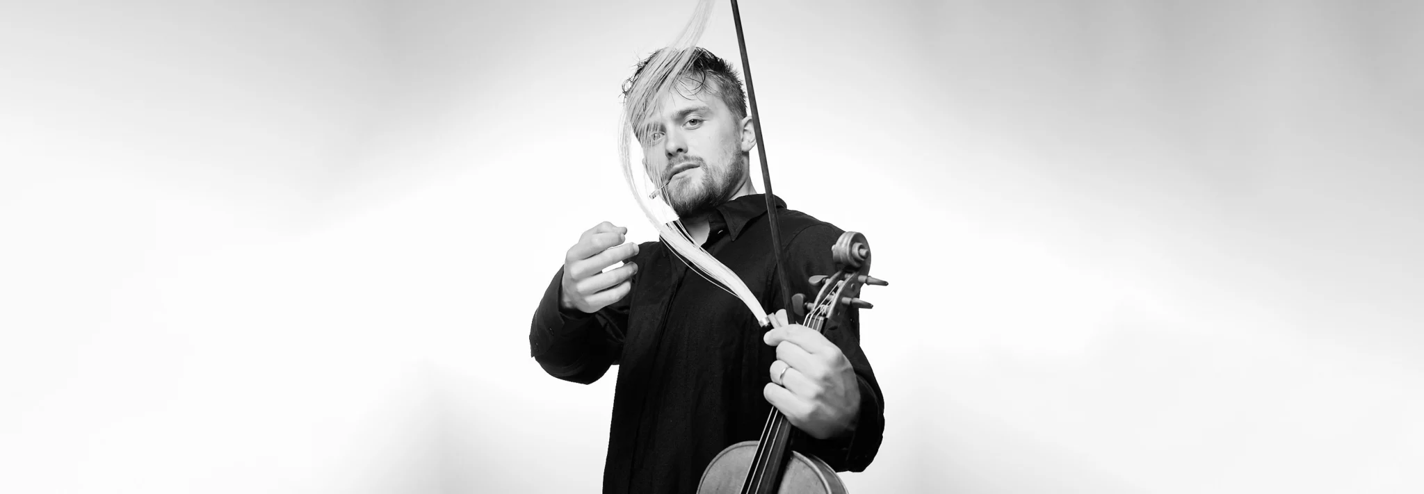 Dmitry Smirnov with violin, bow hair flying across his face. Photo: Matthias Müller